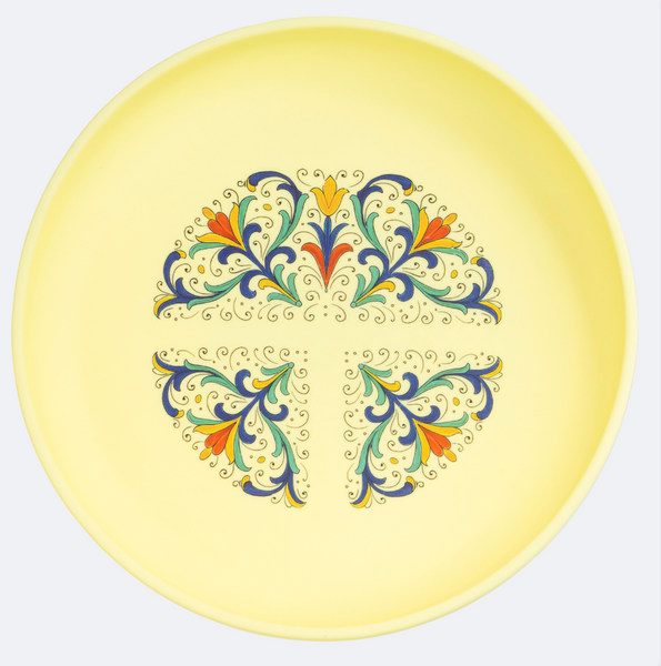 Decorative plate with colorful Deruta pattern on a yellow background